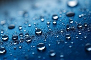 Water beading effect on a ceramic coated car hood showcasing protection