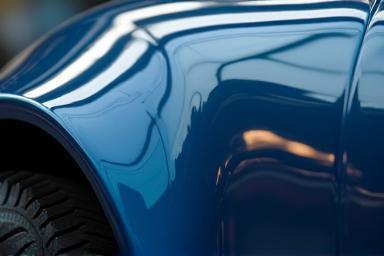 Close-up of a car surface being waxed to a high gloss